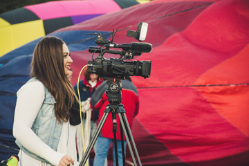 woman operating a video camera